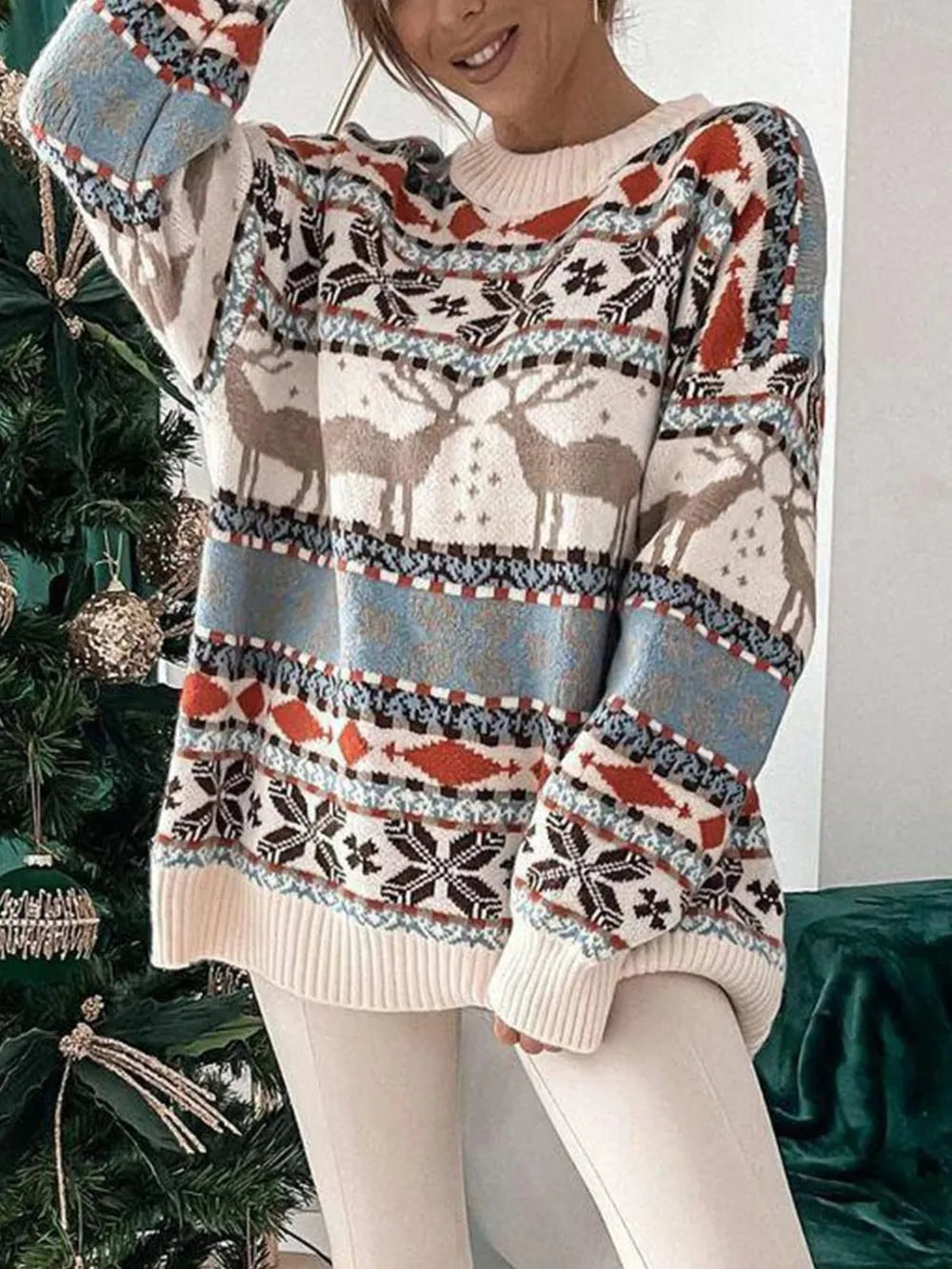Woman wearing the geometric print dropped-shoulder sweater with jeans in a bright, modern living room.